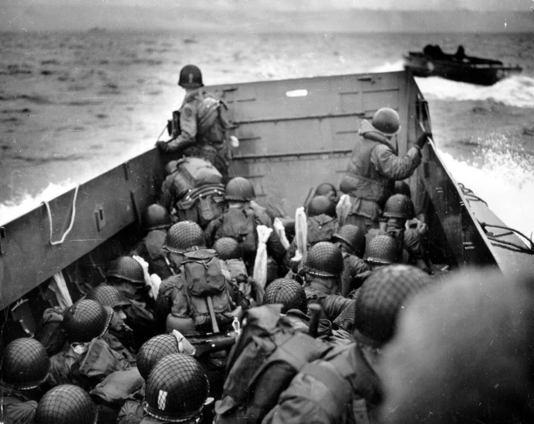 U.S. Army troops crouch behind the bulwarks of a landing craft as it nears Omaha Beach on D-Day. Credit: U.S. Coast Guard photo by Chief Photographers Mate Robert F. Sargent