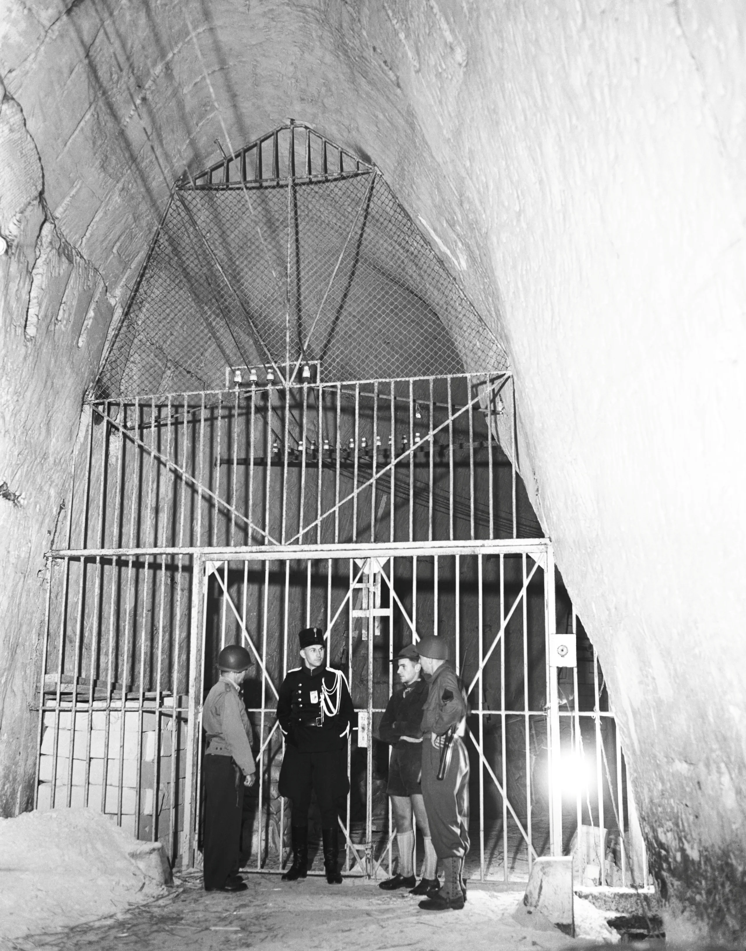 25th September 1944 TOPFOTO CODE: PD3001341 Major Leo Senecao, of Chicopee, Massachusetts: (left) and Sgt. Bernard Sheldon, of New York, N.Y.: Chatting with the Dutch guards at the steel gates of the cave near Maastricht. Here were stored all the priceless art treasures of Holland, safe from bombing and shell fire. The whole treasure house was left intact by the Germans in their hurry to get away. © Topfoto / Peter Deleuran | Used with exclusive permission.