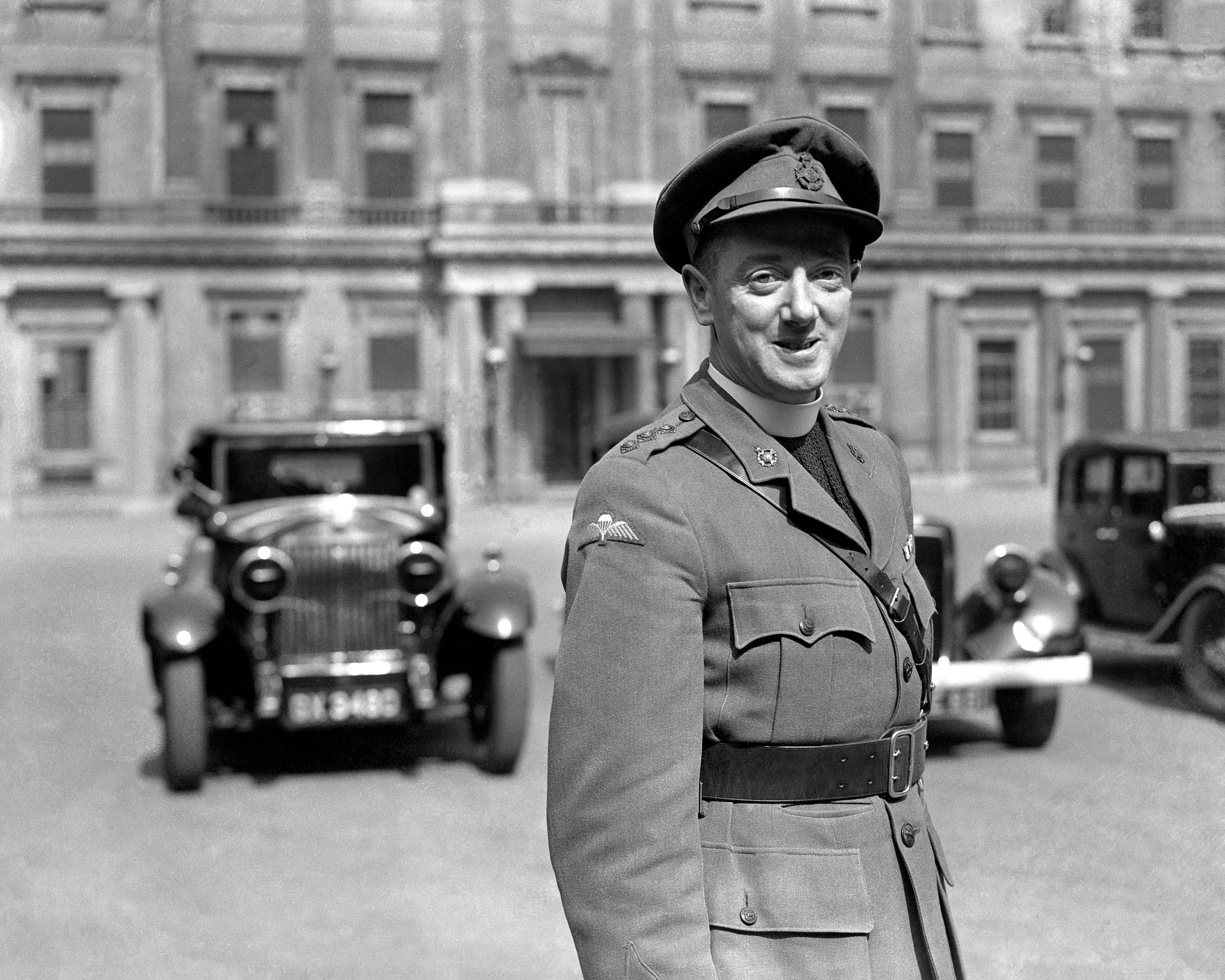 21st April 1944 TOPFOTO CODE: PD3001303 Paratroop sky pilot gets his Military Cross from the King. Photo shows:- The Rev. B.M. Egan, padre of the Paratroop regiment, leaving Buckingham Palace after receiving the Military Cross at a recent investiture. He won his M.C. when he jumped with Paratroopers who invaded Sicily, accompanying them on their mission. Father Egan was games master at Beaumont College, Old Windsor. © Topfoto / Peter Deleuran | Used with exclusive permission.