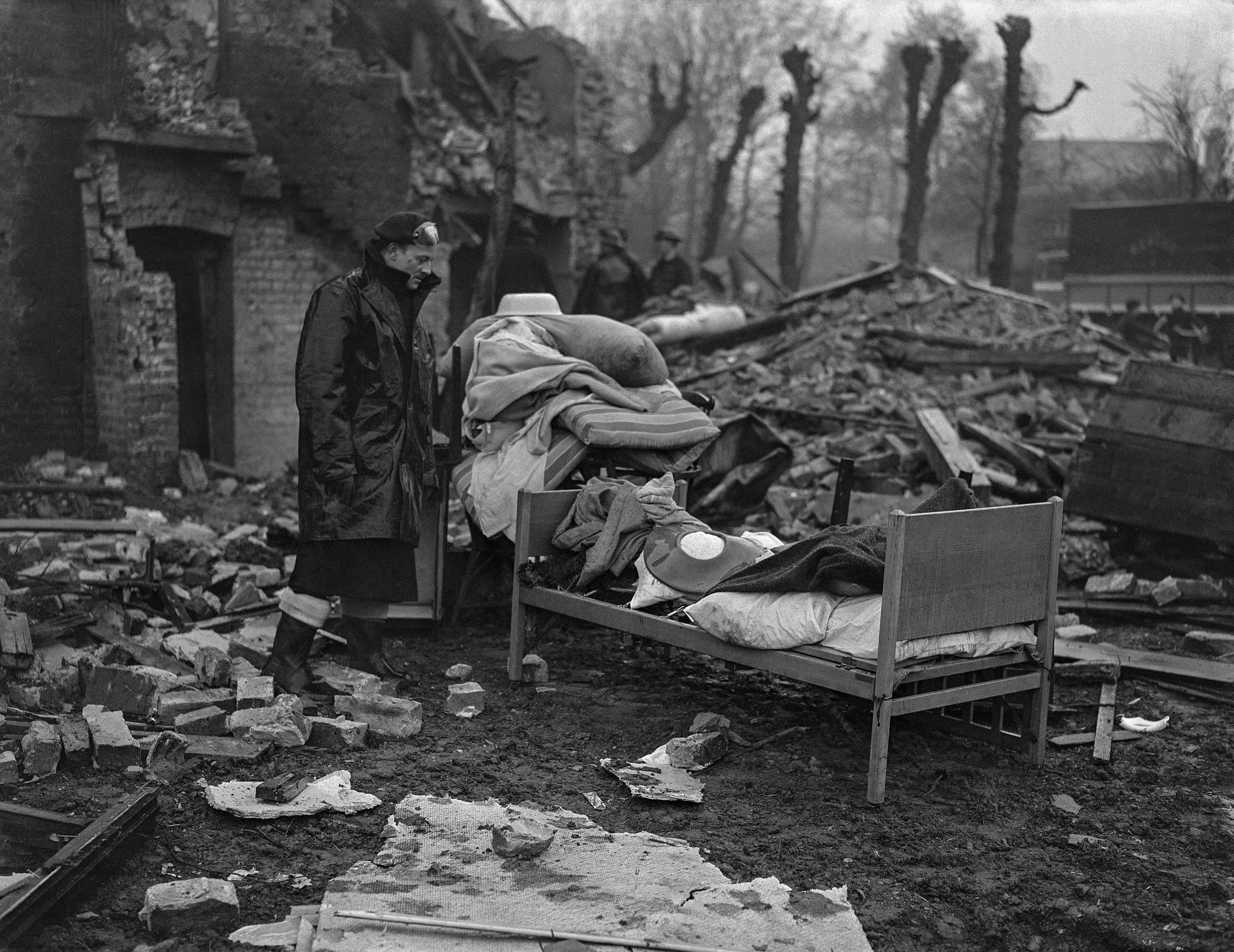 6th November 1943 TOPFOTO CODE: PD3001507 Newly born babies with their mothers were rescued from the debris of a large London nursing home which was bombed during a sharp night raid on the London area. The babies were practically unharmed. Twelve aged invalids were also saved, and rescue workers erected a scaffolding to release two old people trapped in the top floor of the three storey building, which was almost cut in half. Photo shows: Furniture, including a child’s bed, salvaged from the ruins of the nursing home in the London area, damaged during the raid. © Topfoto / Peter Deleuran | Used with exclusive permission.