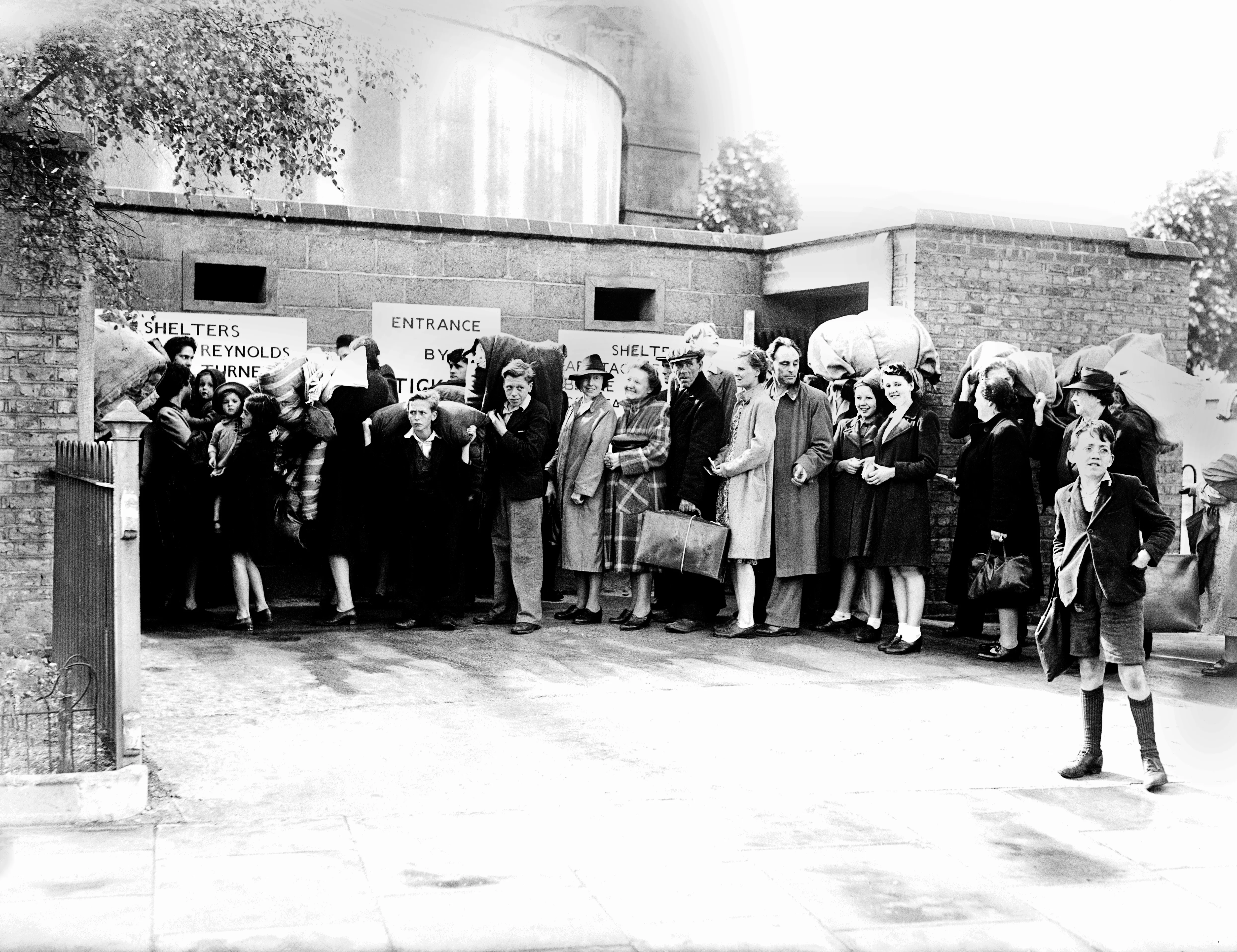11th July 1944 TOPFOTO CODE: PD3001192 The first of a number of deep shelters under London is being used by the public. Photo shows:- People queueing with their bedding outside the shelter. © Topfoto / Peter Deleuran | Used with exclusive permission.