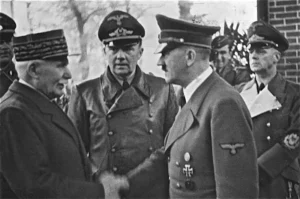 Adolf Hitler greets French Head of State Marshal Henri Philippe Pétain in Montoire-sur-le-Loir. In the center is Chief Interpreter Dr. Paul Schmidt; on the right, Reich Foreign Minister Joachim von Ribbentrop.