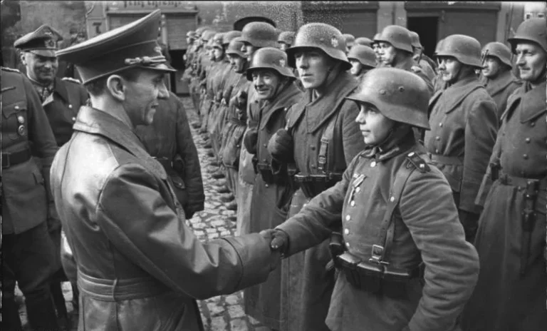 Photograph of Joseph Goebbels awarding 16-year-old Hitler Youth Willi Hübner an Iron Cross for the defence of Lauban
