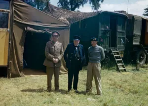 Winston Churchill flanked by the Chief of the Imperial General Staff, Field Marshal Sir Alan Brooke and General Sir Bernard Montgomery, commanding 21st Army Group, at Monty's mobile headquarters in Normandy. June 12, 1944.