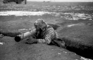 Soldier wearing a gas mask in a trench, aiming a rocket-propelled anti-tank weapon ("Panzerschreck" / "Ofenrohr"); Southern Ukraine