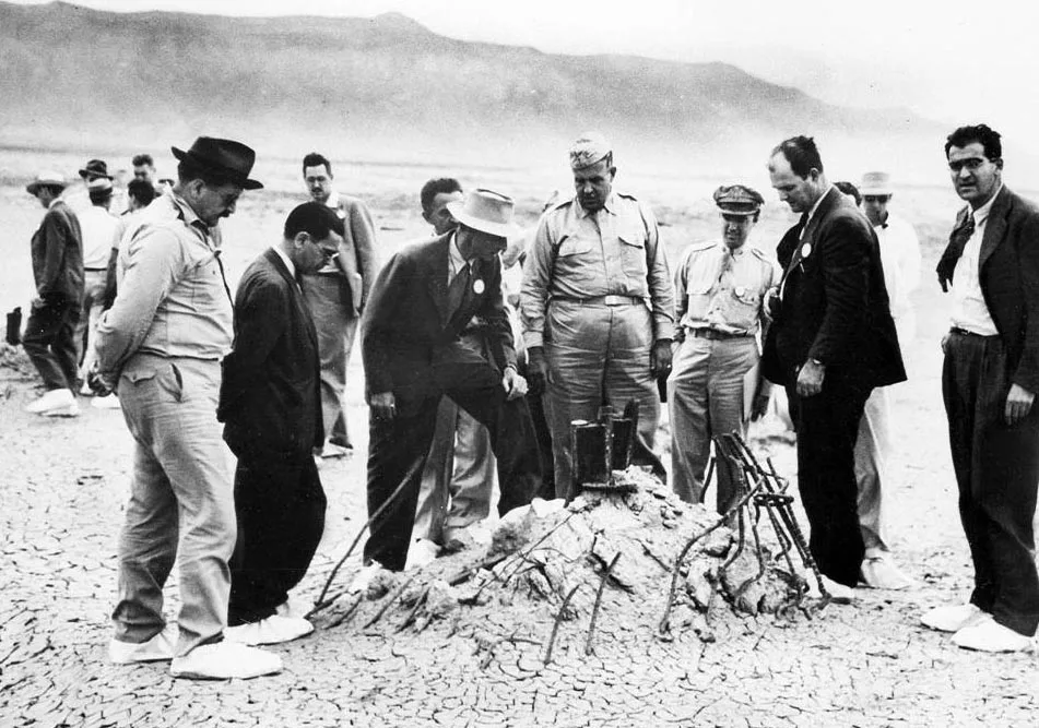 J. Robert Oppenheimer and General Leslie Groves at the ground zero site of the Trinity test